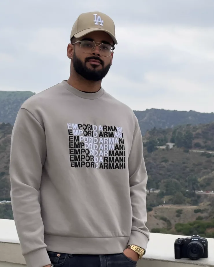 The creator of Try It, Build It standing on a lookout above the Hollywood hills, with a camera on the ledge